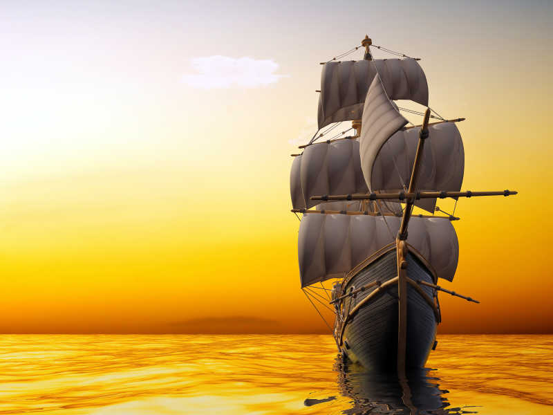 夕阳黄昏下杨帆前行的帆船