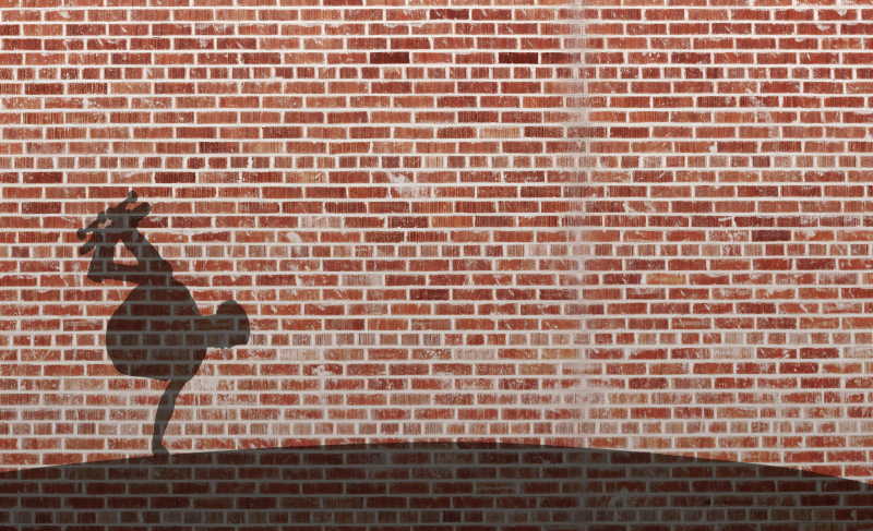 红砖墙上玩滑板男孩的影子