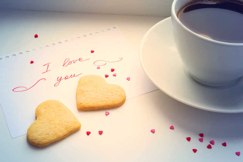 桌上的咖啡与一对心形饼干