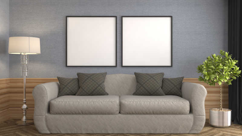 灰色墙壁的空白画框前的灰色双人沙发