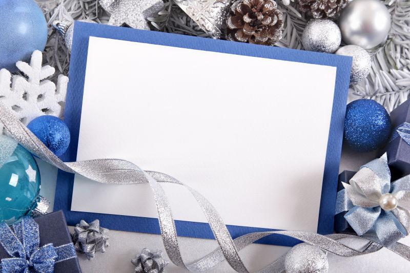 蓝色和银色圣诞节装饰品中的空白圣诞贺卡