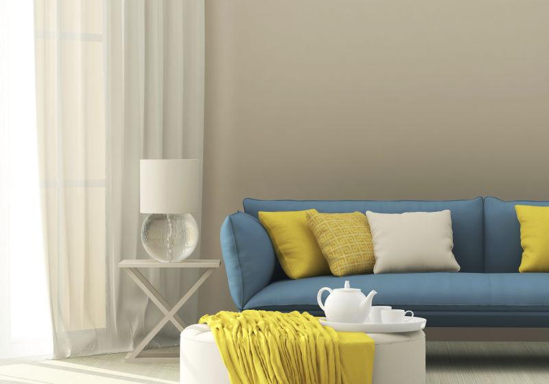 白色简约现代风格客厅里的蓝色沙发和黄色抱枕
