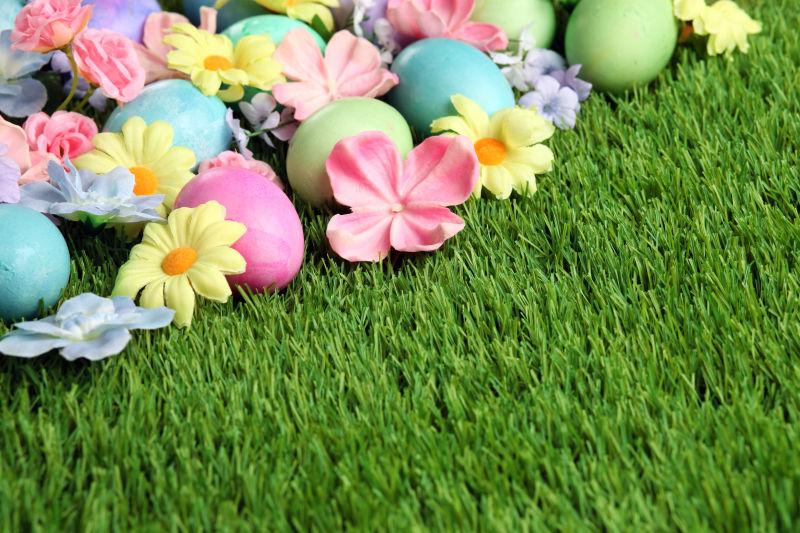 绿色草地上的复活节彩蛋和花朵