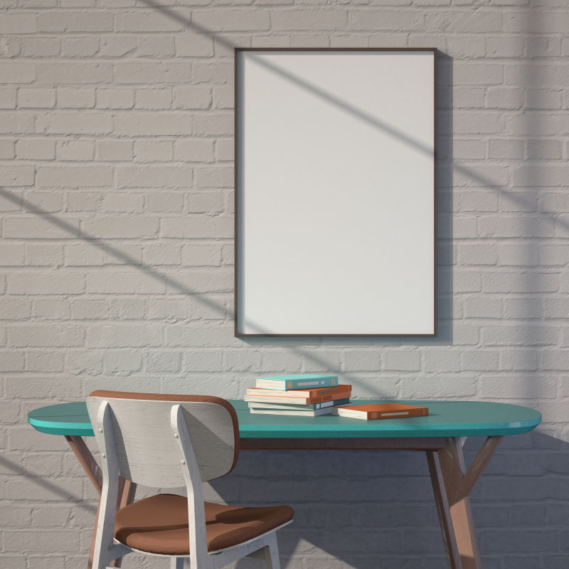 绿色桌子和砖墙上的空白画框