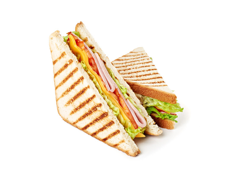 夹火腿奶酪西红柿生菜和烤面包的三明治上图为白底独立视图