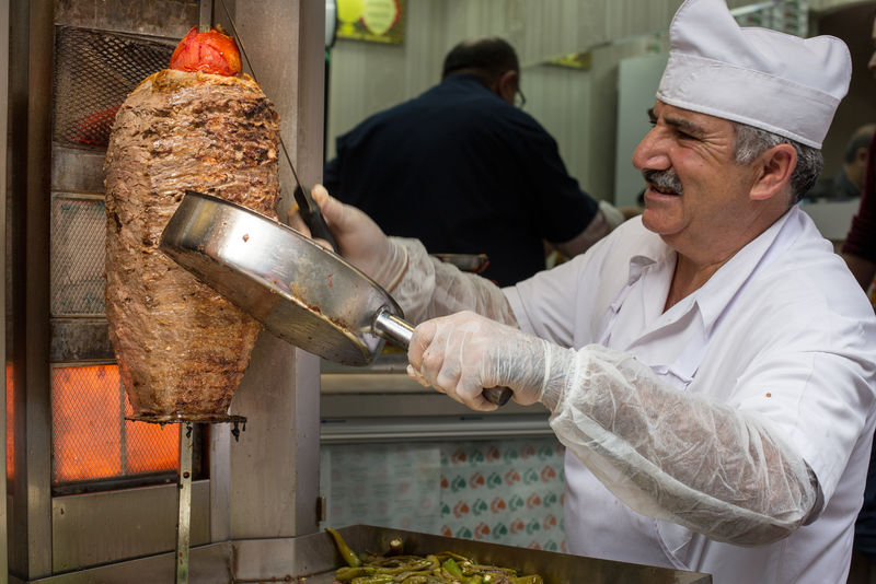 土耳其伊斯坦布尔-2014年10月24日：伊斯坦布尔埃米努区附近的客户提供不明厨师切片Doner Kebap