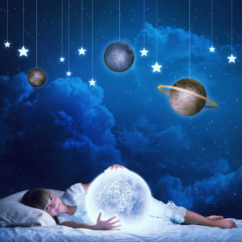 睡觉的小女孩看着发光的星球