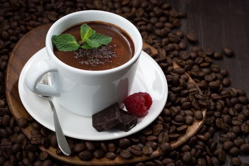 木制背景下的咖啡豆和一杯热巧克力