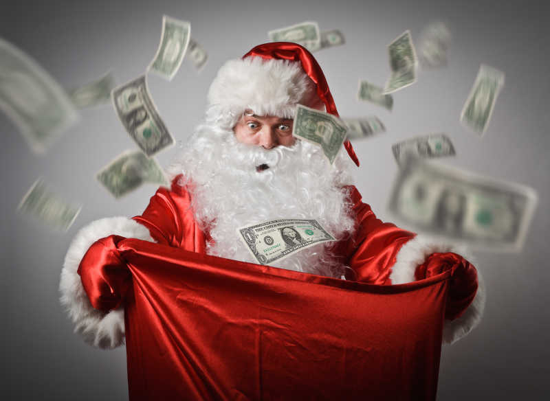 手拿红色布袋收集美元的圣诞老人